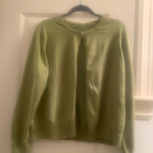 Green cardigan with jewel neckline.